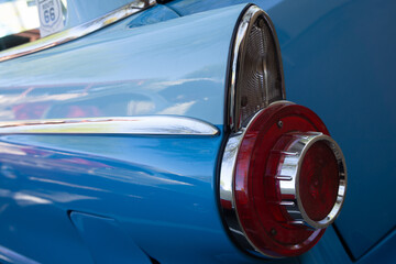 Closeup of the tail fin on a blue classic 1950s automobile © A. Brownfield Brown