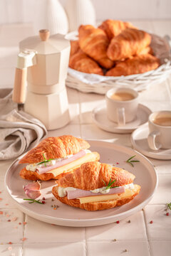 Homemade and golden french croissant served with coffee.