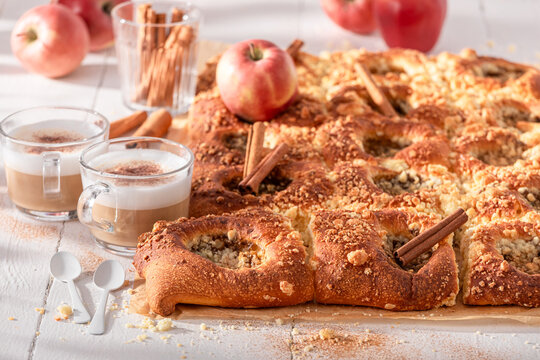 Homemade and sweet apple yeast cake flavored with cinnamon.