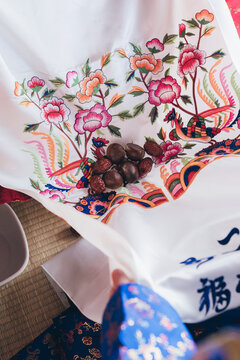Close up of jujube dates received during Korean traditional wedding pyebaek ceremony, Close up of traditional Korean wedding Pyebaek ritual with chestnuts and jujubes on embroidered silk fabric

