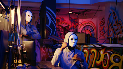 Hacker group members doing online terrorism acts, filming ransom video with smartphone in hidden...
