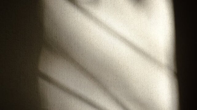 Textured wall on which gleams of light cast fanciful shadows. The twilighty shadows danced across the light background, Surreal backdrop, overlay shadows. Wonders of refraction caustic light.