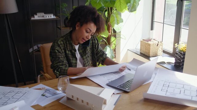 African American lady architect designer talks on mobile phone
