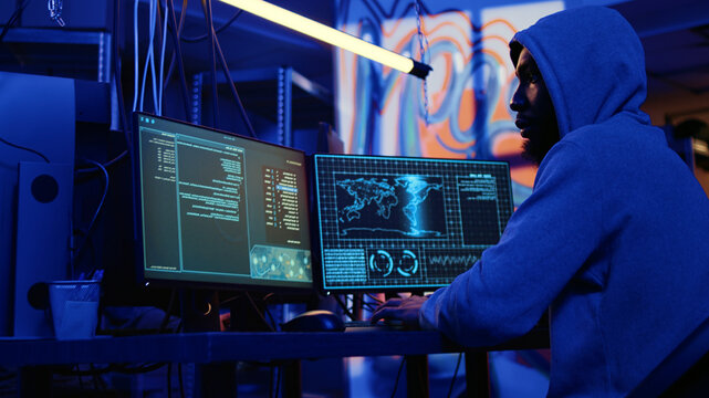 Hacker with malicious intent doing data breaches and financial theft in dark bunker, cybercriminal stealing users bank account credentials, targeting low security passwords.
