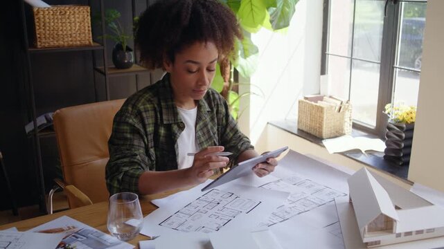 Young African American designer draws draft on digital tablet