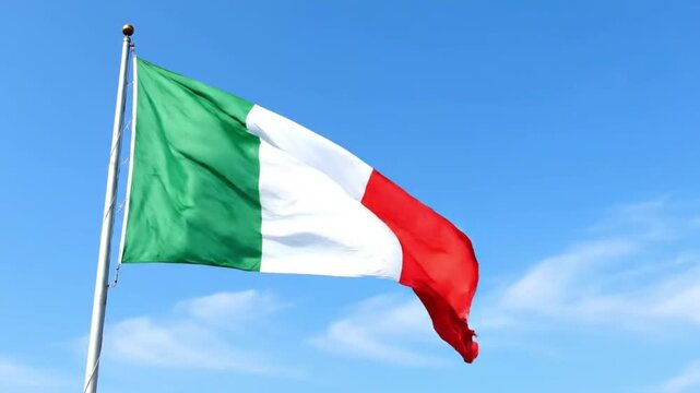 National flag of Italy waving on flagpole under bright blue sunny sky