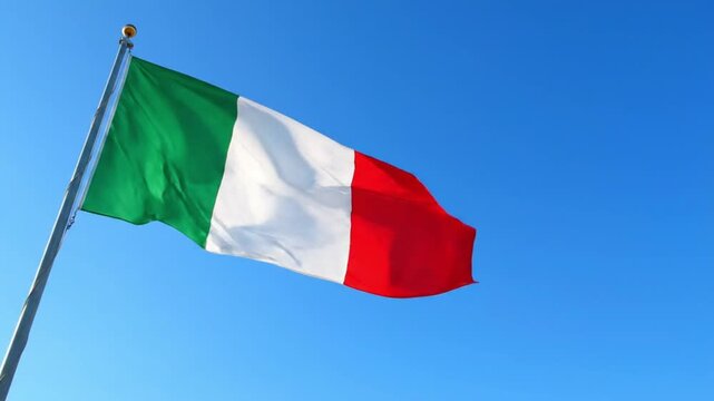 Italian flag waving on flagpole against clear blue sky