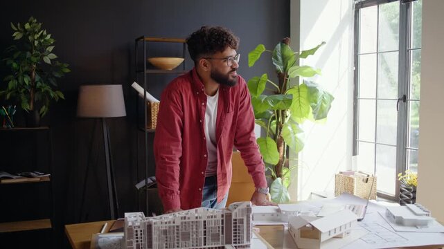 Arab architect reviews scale building models during planning