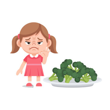 A young girl looks unhappy while refusing to eat a plate of green broccoli