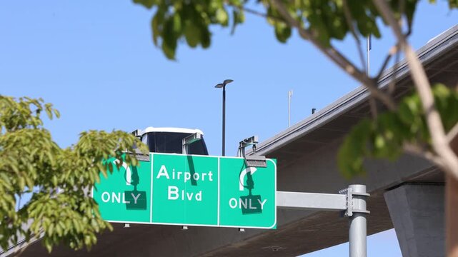 Airport Blvd Road Sign With LAX SkyLink Train Passing Above