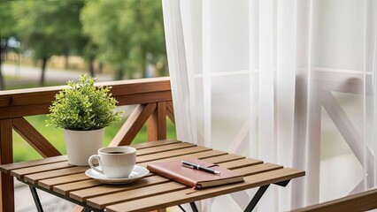 Obraz premium Morning coffee and notebook on wooden balcony table.