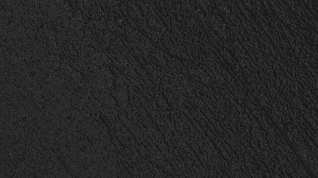 Dark textured surface with subtle vertical ridges, fine grain, and uniform matte appearance. Grunge texture background animation.
