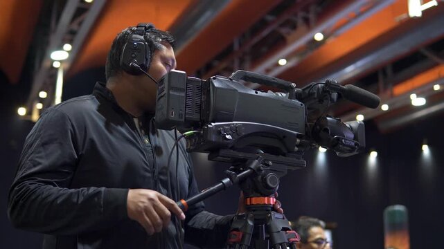 Professional latino camera operator broadcasting live event
