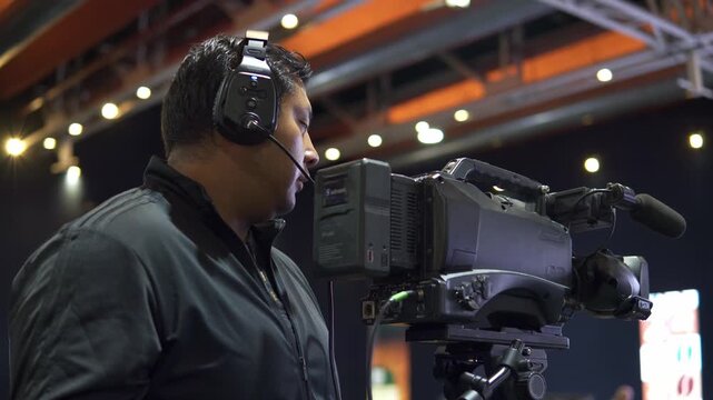 Professional camera operator filming live television broadcasting
