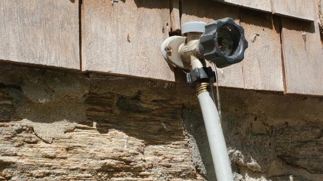 Leaking outdoor spicket dripping water at hose connection
