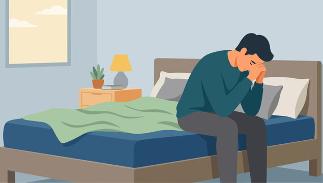 A man sitting on bed feeling sad.
