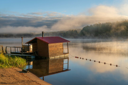 Wooden bathhouse on the shore of Lake Ladoga near the village of Lumivaara on a foggy autumn morning, Ladoga Skerries, Lahdenpohya, Republic of Karelia, Russia