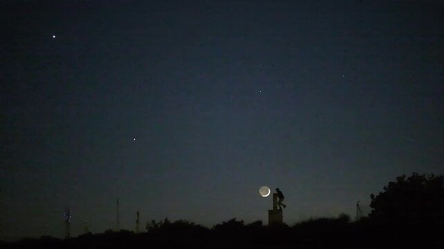 Astrophotography timelapse of rare planetary alignment with stars and astronomer silhouette