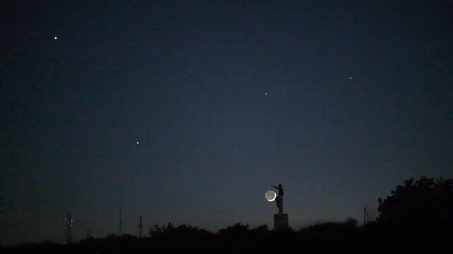 Night sky time lapse of celestial conjunction with male silhouette stargazing