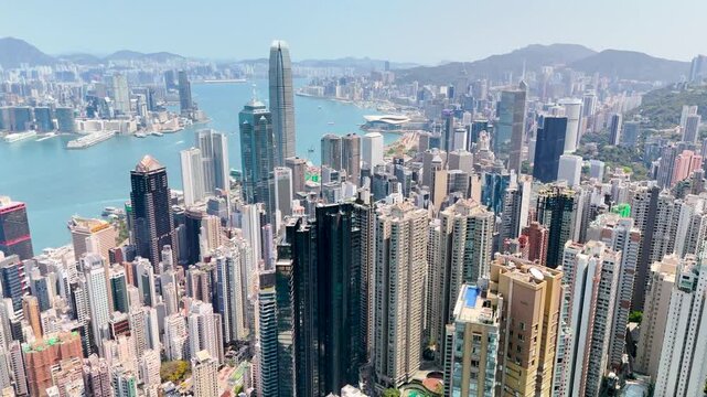 Panoramic view from above of the forest peak slope and view of the high-rise skyscrapers of Hong Kong city