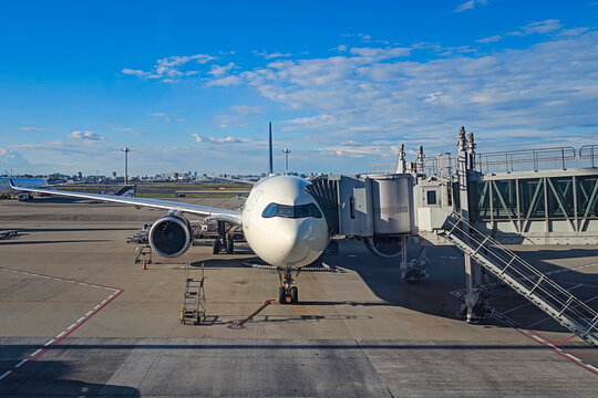 Airliner at jet bridge in international airport during refueling