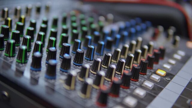 Audio mixing console board with knobs