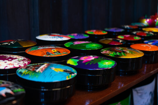 Colourful handcrafted decorative boxes displayed for sale, showcasing art, craftsmanship and cultural heritage. Traditional showpieces inspired by Hoi An and UNESCO tourism appeal globally.