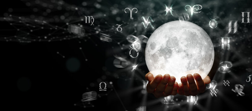 Mystical hands holding glowing moon with astrological symbols floating around in cosmic space