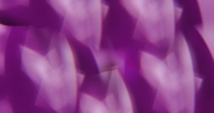 Blur flicker glare. Glimmer art. Defocused purple lilac color lens flare kaleidoscope floating on light visual abstract vibrant background.