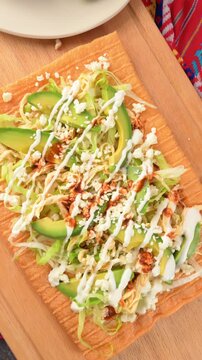 Camera rotating on slow motion, chicharron preparado on wooden surface, typical Mexican fast food and appetizers