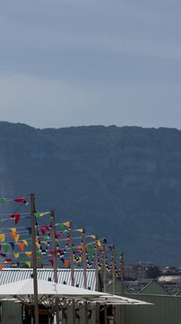 Colorful Bunting Flags Waving at Outdoor Cafe Near Lake Geneva Mountains