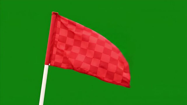 Red Corner Flag Waving in Wind Green Screen - A red corner flag with a checkered pattern whips and waves dynamically in the wind against a solid green background.