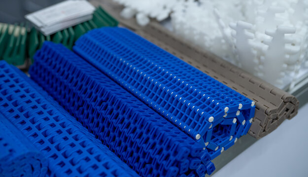 Modular plastic conveyor belt for smart industrial solutions. Innovative transport system enhancing manufacturing efficiency. Machinery component for diverse production. Equipment for modern factory.