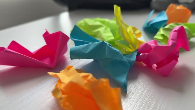 Colorful Crumpled Sticky Notes Scattered on Desk Planning Stress Concept