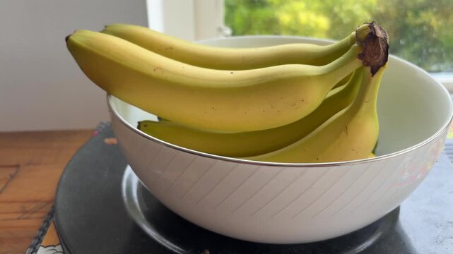 Bananas in Fruit Bowl on Kitchen Counter Healthy Eating Concept