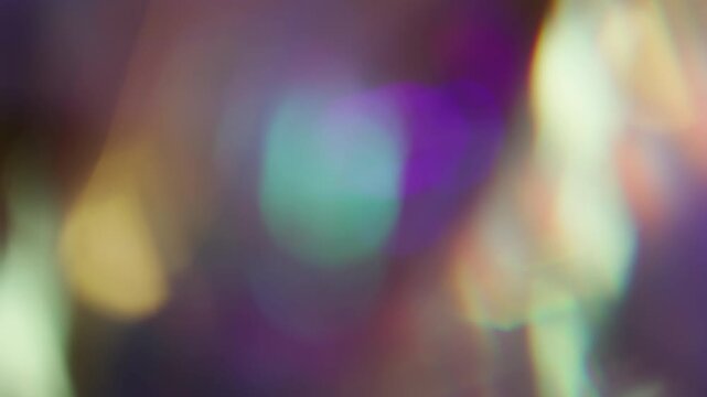 Bright refracting blur. Colorful glow. Faceted crystal diamond twinkle luminosity texture. Optical blue orange bokeh reflection background.