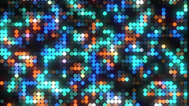 Abstract background of vibrant colorful circular LED lights flashing and glowing for a digital technology or nightclub disco party concept