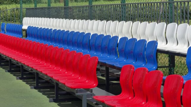 Russian flag Empty Stadium Seating: Rows of vibrant red, white, and blue seats await spectators in an empty stadium, hinting at a future event.