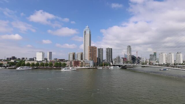 Aerial view of the Erasmusbrug bridge and the modern skyline with the Zalmhaven tower over the Nieuwe Maas river in Rotterdam, Zuid-Holland, Netherlands.
