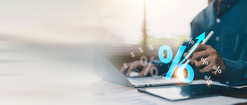 Interest rate growth and financial investment concept with percentage symbols, upward arrow and digital business analytics. Business professional analyzing profit increase, savings returns, fintech