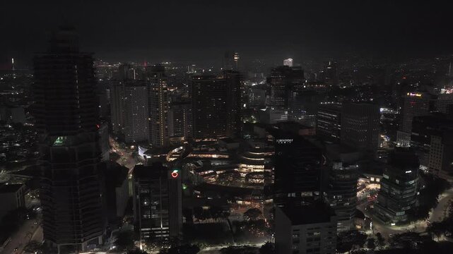 Aerial view of the illuminated city skyline with skyscrapers and urban lights at night in Cebu City, Central Visayas, Philippines.