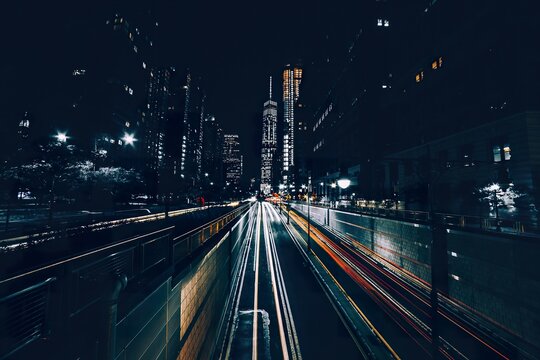 Night city street with light trails from moving cars