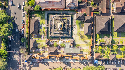 Fototapeta premium Aerial drone view of traditional Balinese Hindu temple architecture, complex design and rooftops in Bali, Indonesia