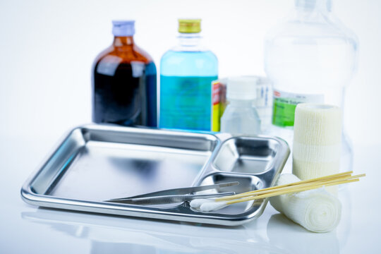 Medical equipment for treating infections. Wound care dressing set. Medical supplies for nurses. Conform bandage, forceps, cotton stick, alcohol. Sterile dressing materials. Healthcare equipment.