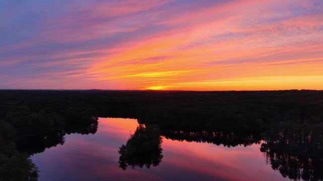 Forward drone view during a golden sunset at Harold Parker State Forest in Massachusetts, USA