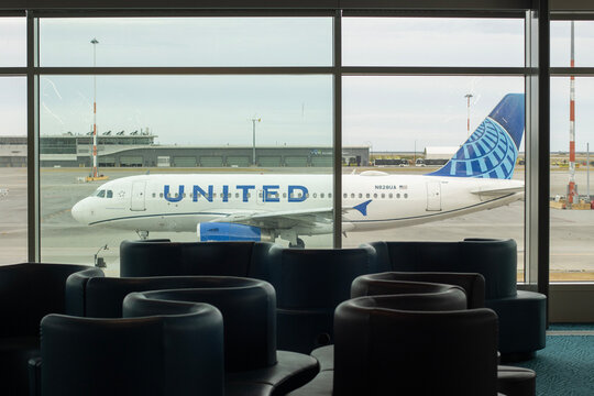 Richmond, BC, Canada - June 13, 2023: An Airbus A319-131 aircraft operated by United Airlines is seen taxiing on the tarmac through terminal lounge windows at Vancouver International Airport (YVR).