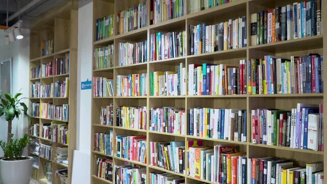 Clean and organized modern library interior featuring endless rows of textbooks and literature