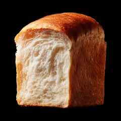 Half loaf of soft milk bread shokupan isolated on black background with clipping path, concept of bakery freshness qualities © boule1301