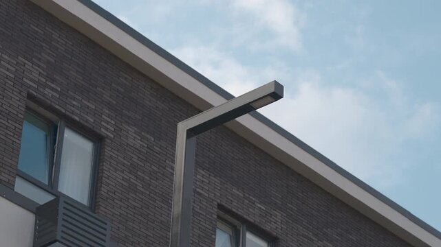 Low Angle View of Modern Brick Building Facade with Streetlight