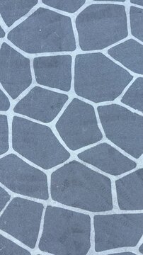 grey concrete with stone stencil pattern outdoors on footpath